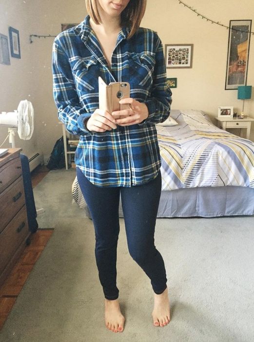 A reviewer showcasing dark wash jeggings paired with a classic blue plaid shirt, adding a chic touch to casual style.