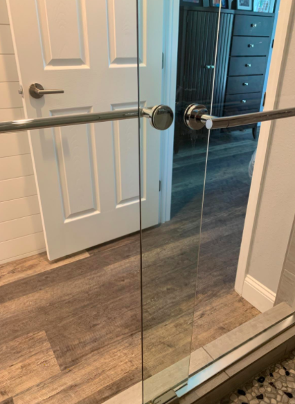 After using the hard water stain remover, the reviewer's shower door sparkles like new.