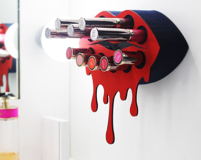 The lip-shaped lipstick holder, displaying a variety of lipsticks and glosses.