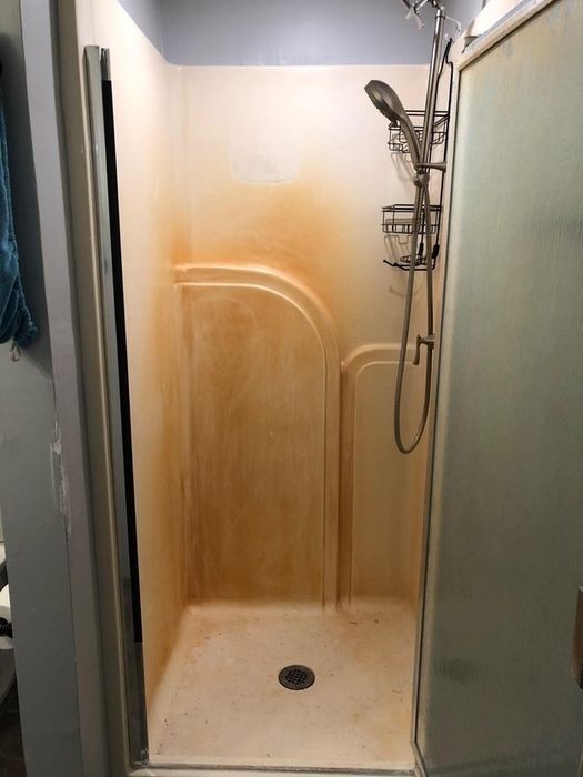 A rusty shower before being cleaned with Iron Out.
