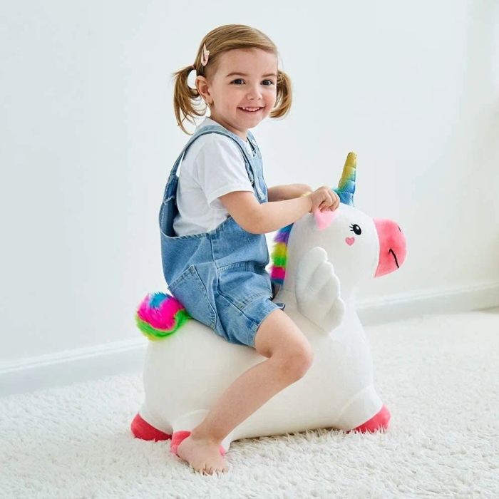 A child enjoying a ride on the toy unicorn