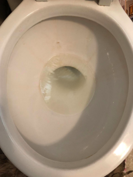 On the right, the same toilet with significantly fewer rings after using the pumice stone.