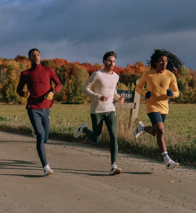 Three runners moving along a dirt road