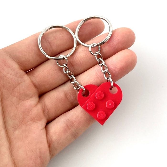 The red heart keychain being held in someone's hand