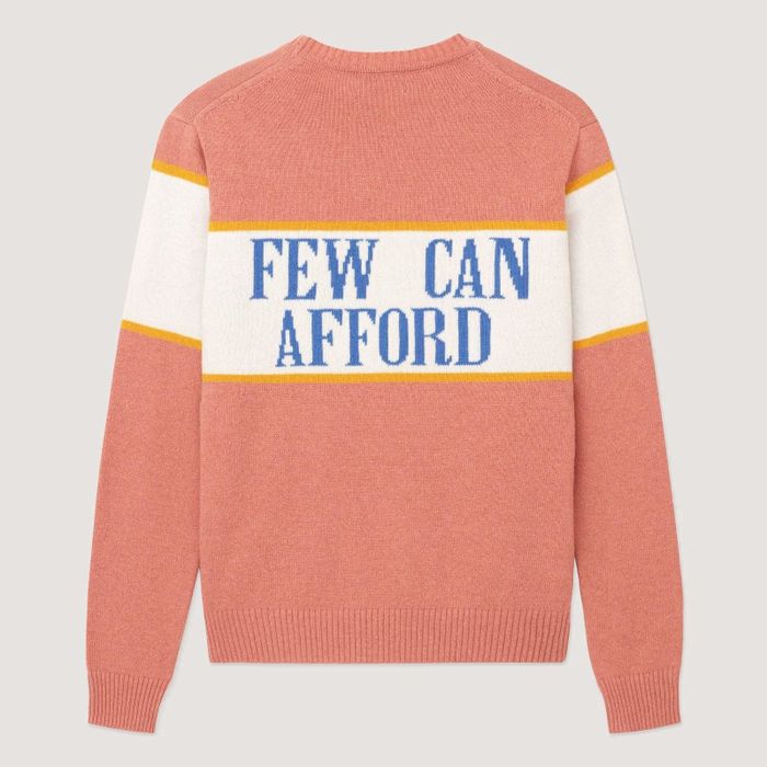 The back of the sweater displays the message, 