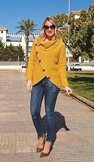 A model is seen wearing the sweater in a bold mustard yellow shade.