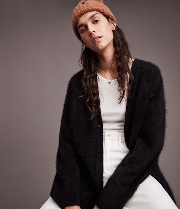 a model showcasing a cashmere black eyelash cardigan