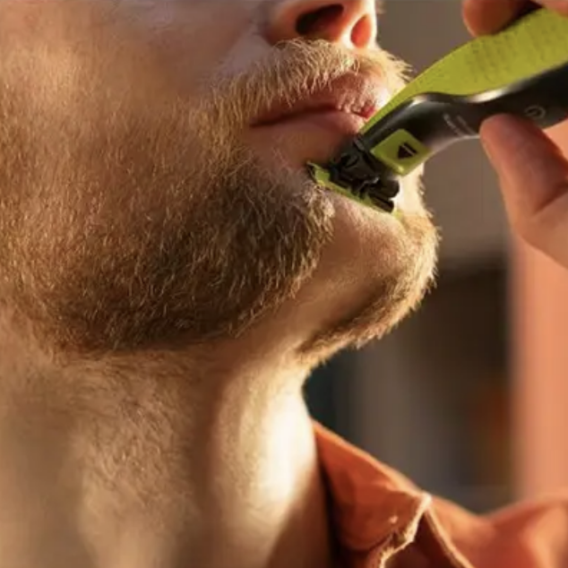 A man shaving his face completely