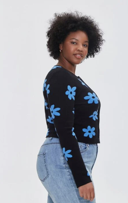 The same model is seen wearing the cardigan adorned with blue flowers, showcasing its colorful and floral charm.