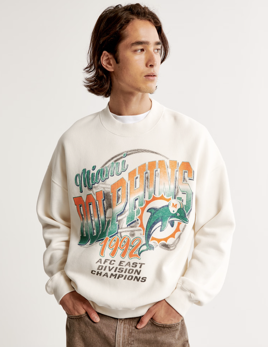 A man sporting a vintage Miami Dolphins crewneck
