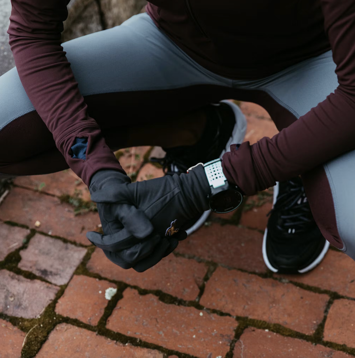 A close-up of a runner wearing the black gloves