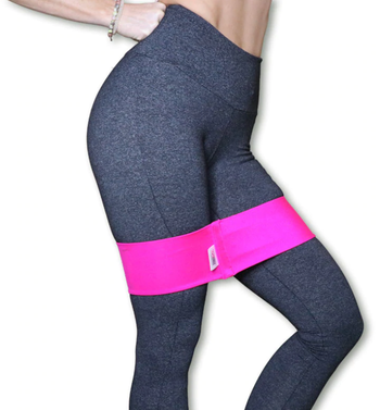 A model demonstrating the pink booty band during a workout