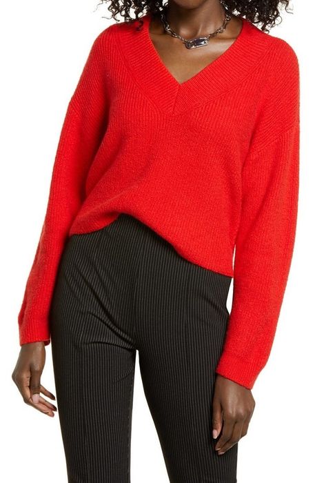 a model wearing a red V-neck sweater