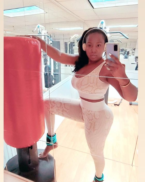 A reviewer wearing the white snake print set