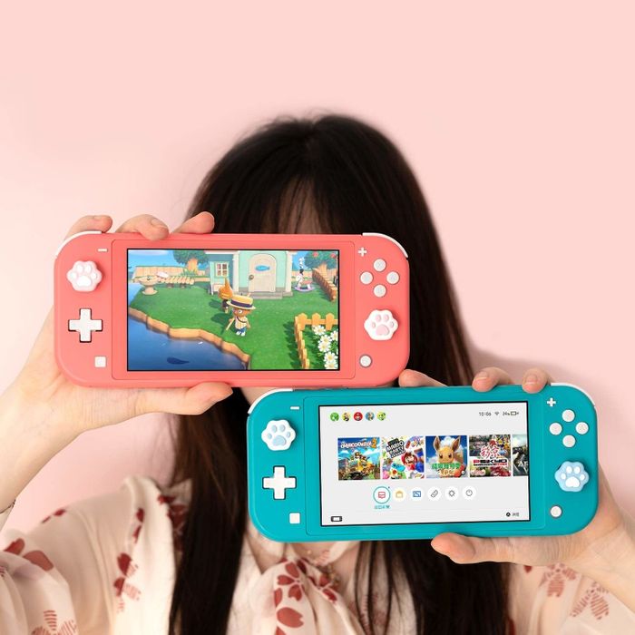 A model showcasing the paw prints on both a pink and a blue Nintendo Switch Lite