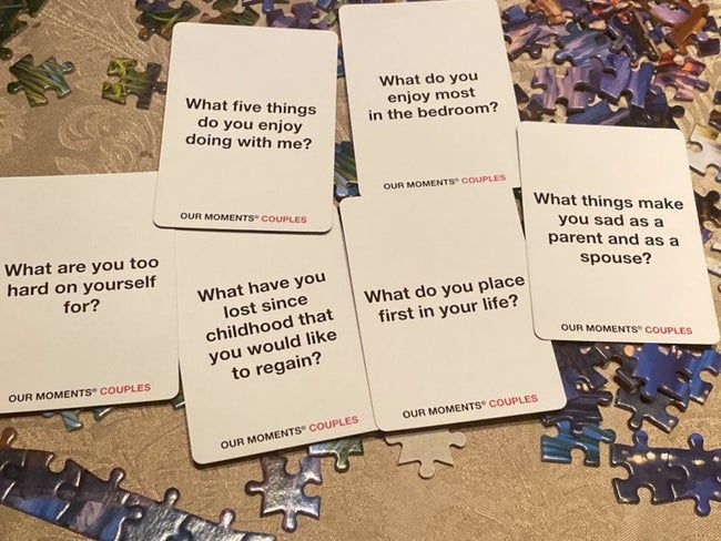 A reviewer photo showing some of the cards, which include questions like