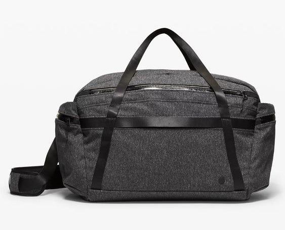 The gray duffle bag featuring sleek black straps