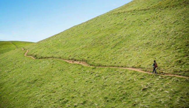 Person hiking along a scenic trail