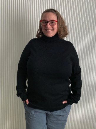 A reviewer is wearing a black turtleneck sweater.