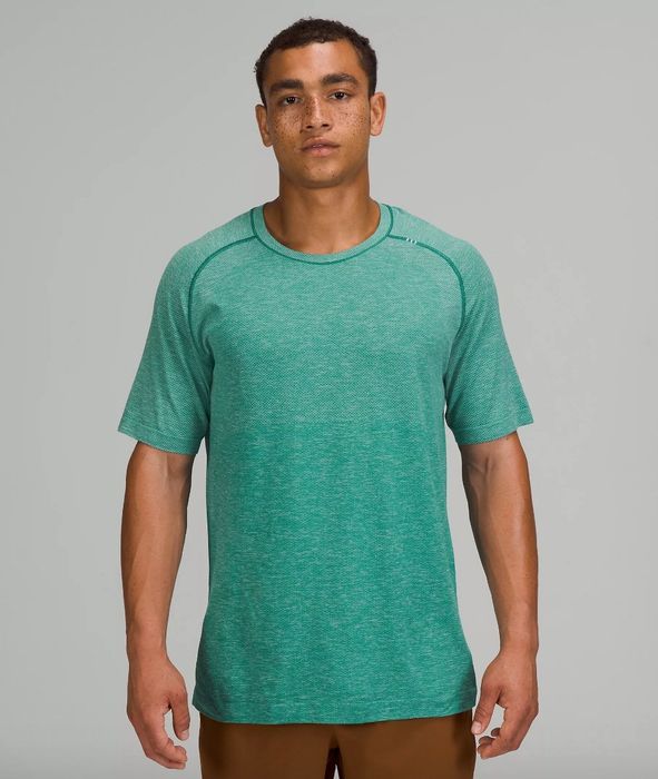 A model sporting a teal ventilated T-shirt with brown pants