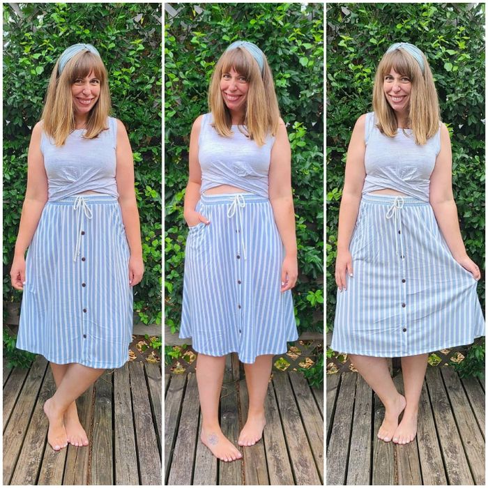 A reviewer styling a blue twist-front crop top with a striped midi skirt