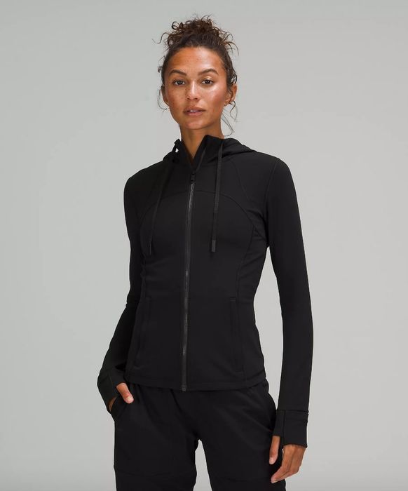 Model wearing a sleek black zip-up hoodie