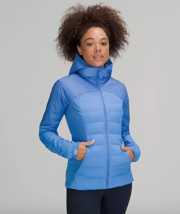A model wearing a blue running jacket