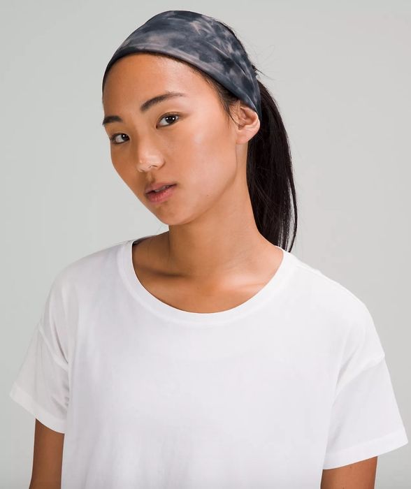 A model sporting a black tie-dye headband