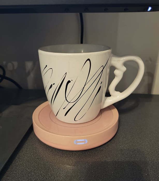 A close-up of someone's coffee mug resting on their desk