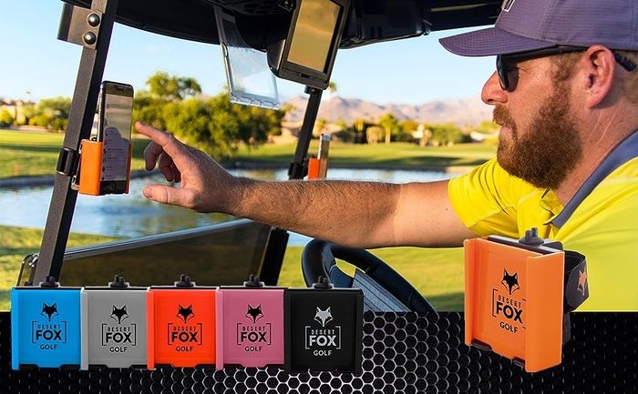 A man using his phone while it's securely attached to a golf cart