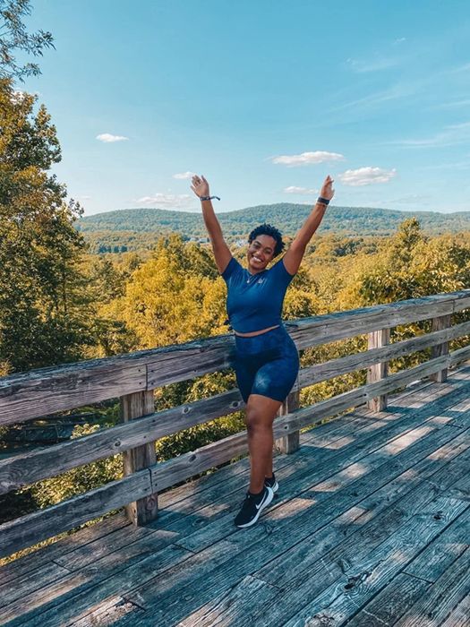 A reviewer rocking the bike shorts in a blue snake print design