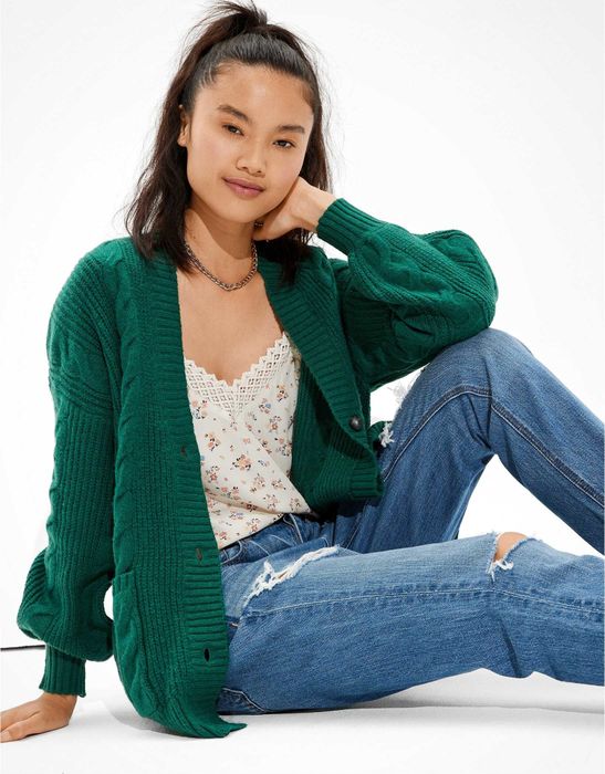 A model dons a stylish oversized green cardigan.