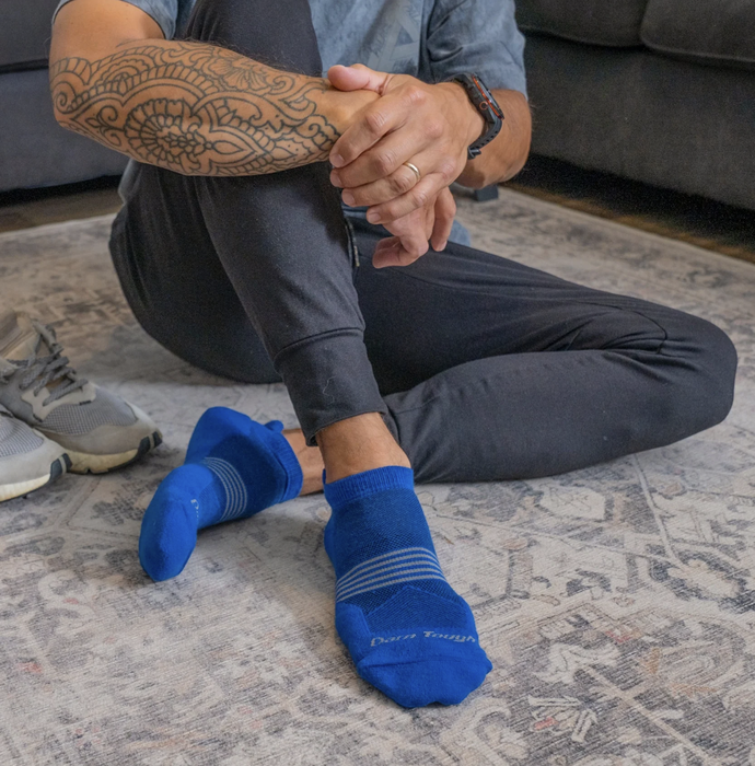 A close-up of someone's blue running socks