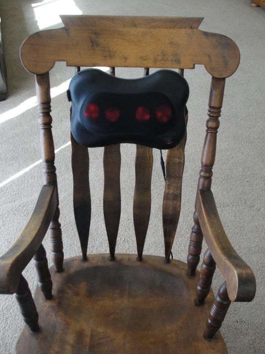 The massager secured to the back of a chair