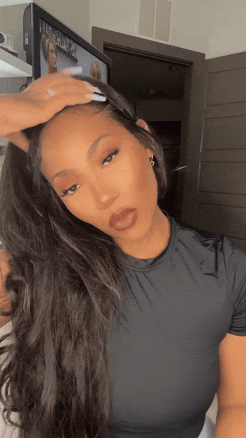 Jordan Grigsby is seen styling her hair in this moment.