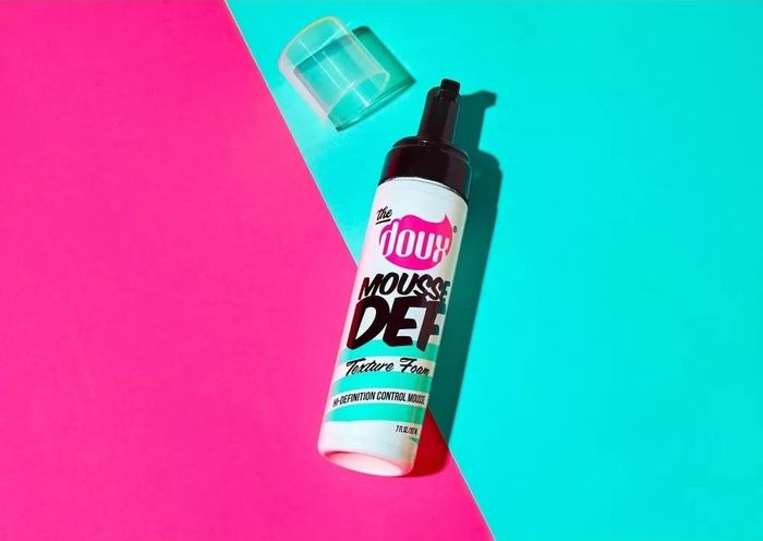 A bottle of hair mousse labeled