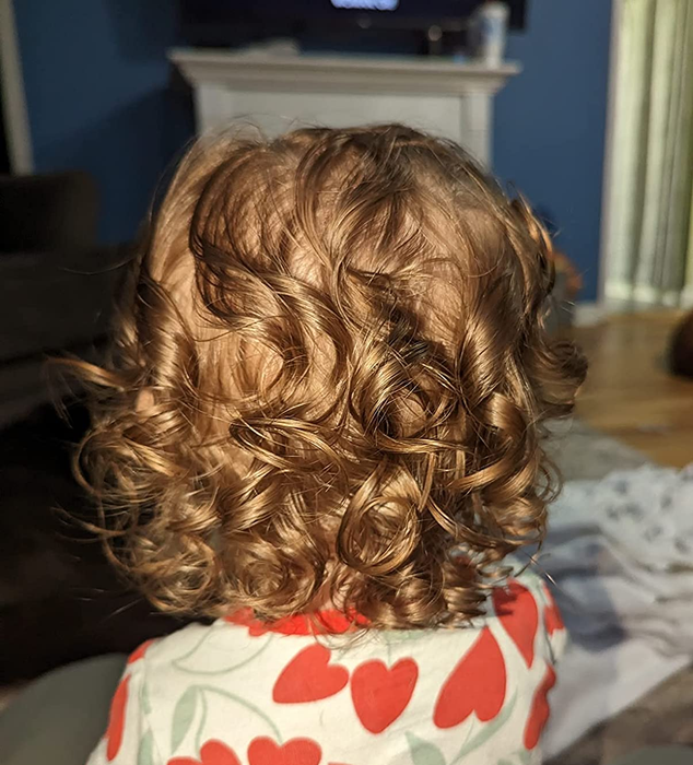 Image of another reviewer's child sporting healthy, bouncy curly hair.