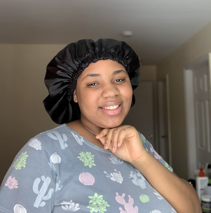 An image of a reviewer wearing the black silk bonnet.