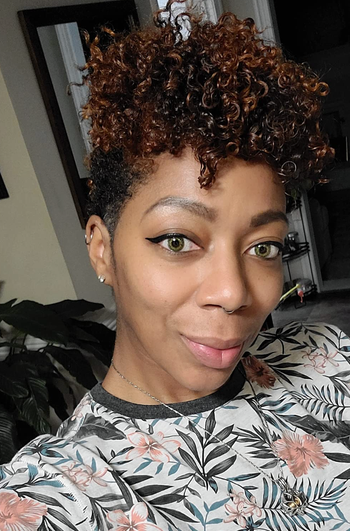 The reviewer’s curls are beautifully defined after using the mousse.