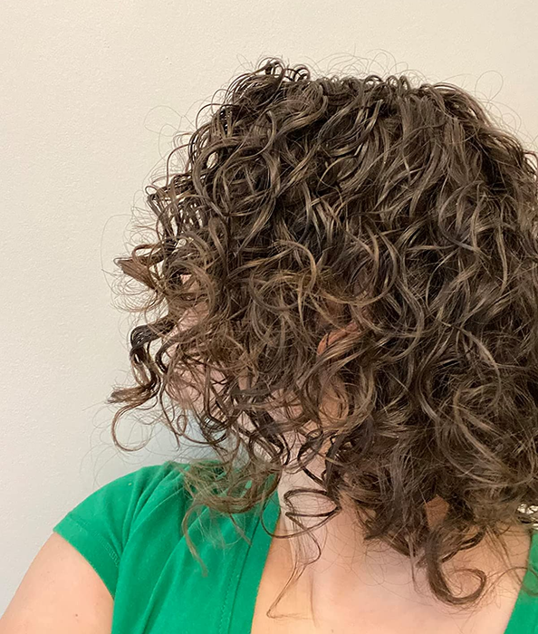 reviewer with vibrant curly and wavy hair
