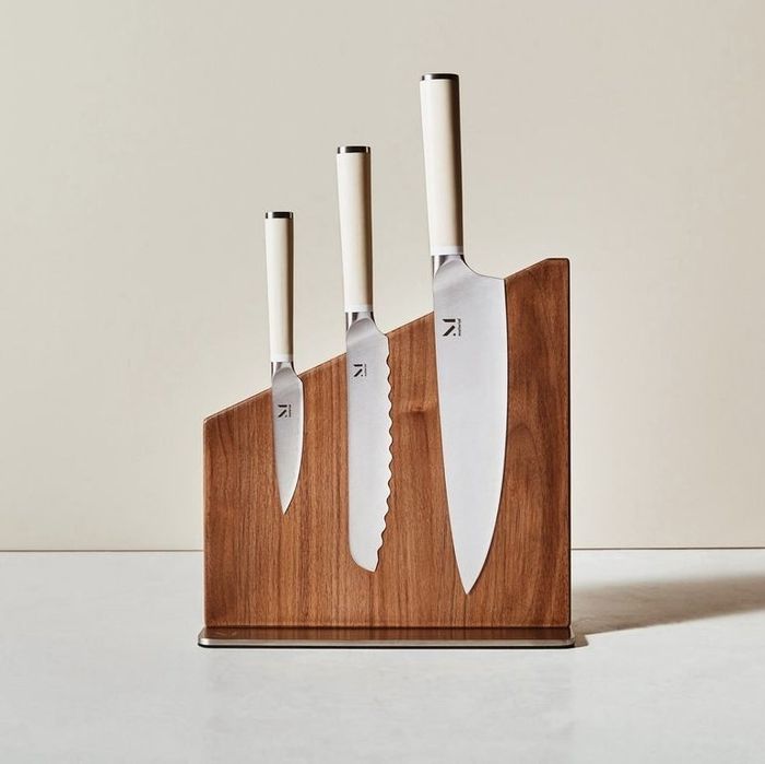a set of three knives housed in a wooden block