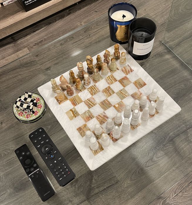 Isabella's beautifully styled chessboard placed on her coffee table, combining functionality and modern design.