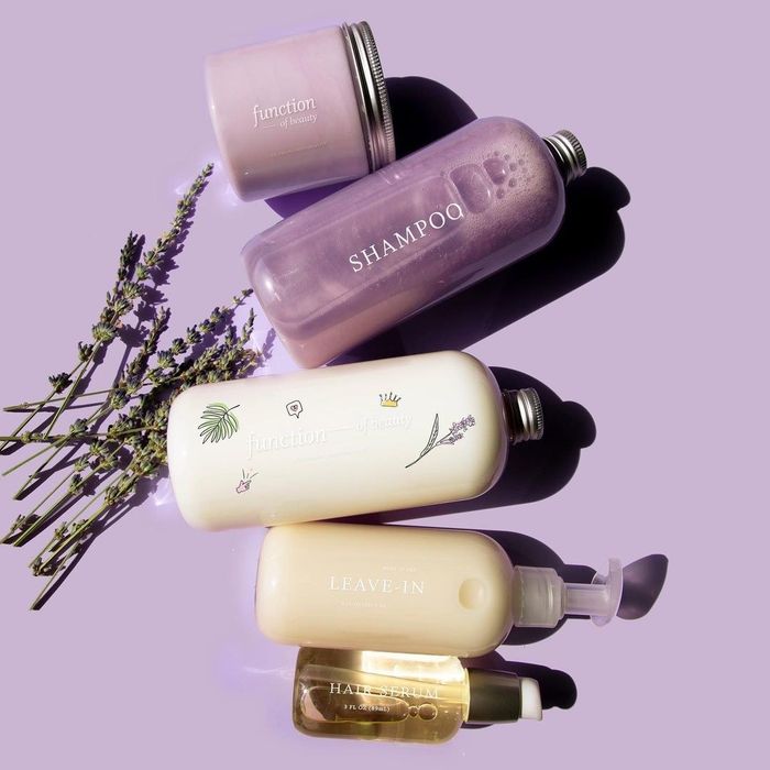 bottles of shampoo, conditioner, hair serum, and leave-in conditioner.