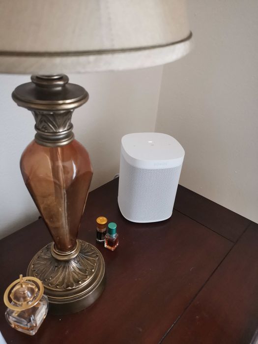 A reviewer's Sonos speaker placed on a nightstand, offering easy access to high-quality sound.