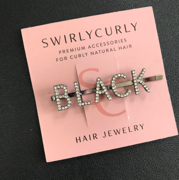 A glittery hairpin spelling out 