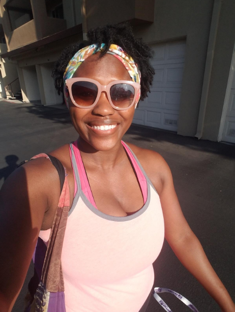 A reviewer wearing the headband while keeping their hair in place
