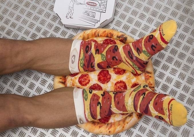 A model wearing socks that are designed to resemble a pepperoni pizza.