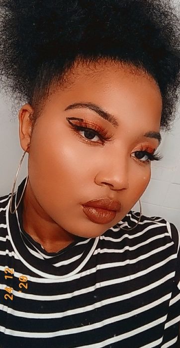 a selfie of the reviewer sporting graphic eyeliner while wearing the foundation
