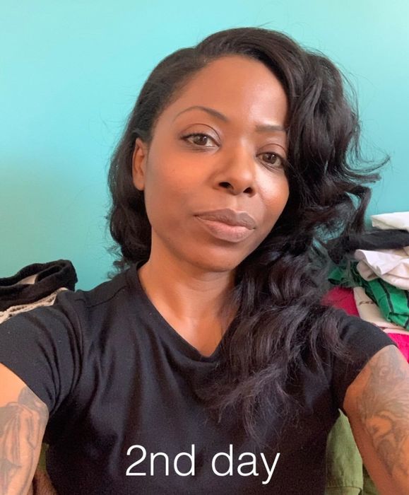 Same reviewer after using the product, showing 'day 2' hair.