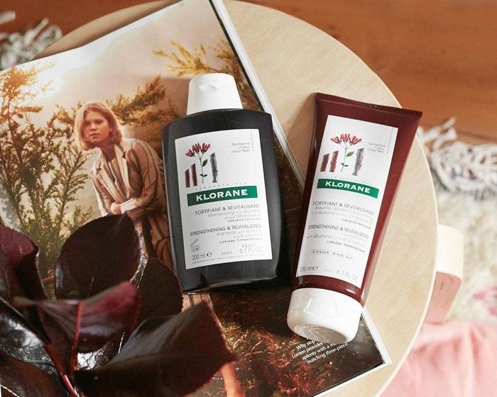 A bottle of shampoo and conditioner placed side by side.